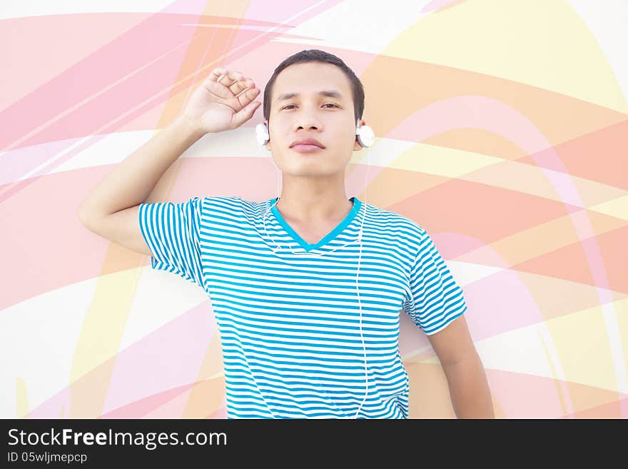 Asian Man Posing With Colorful Background  And Listening To Music. Asian Man Posing With Colorful Background  And Listening To Music