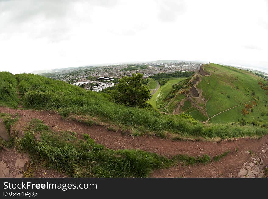 Arthur's Seat is the main peak of the group of hills which form most of Holyrood Park. It is situated in the centre of the city of Edinburgh, about a mile to the east of Edinburgh Castle. The hill rises above the city to a height of 250.5 m (822 ft), provides excellent panoramic views of the city, is relatively easy to climb, and is popular for hillwalking. Arthur's Seat is the main peak of the group of hills which form most of Holyrood Park. It is situated in the centre of the city of Edinburgh, about a mile to the east of Edinburgh Castle. The hill rises above the city to a height of 250.5 m (822 ft), provides excellent panoramic views of the city, is relatively easy to climb, and is popular for hillwalking.