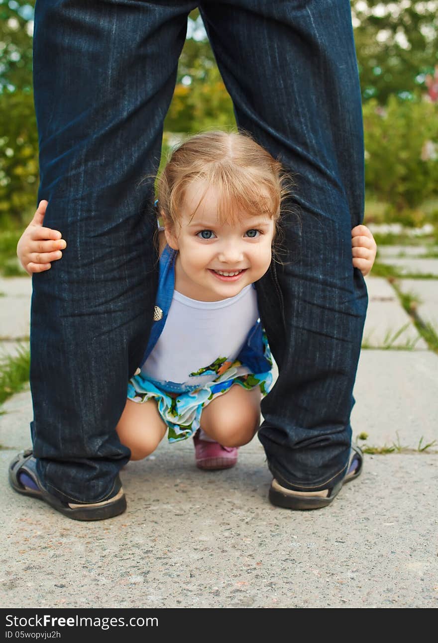 Little girl holding the feet of parents