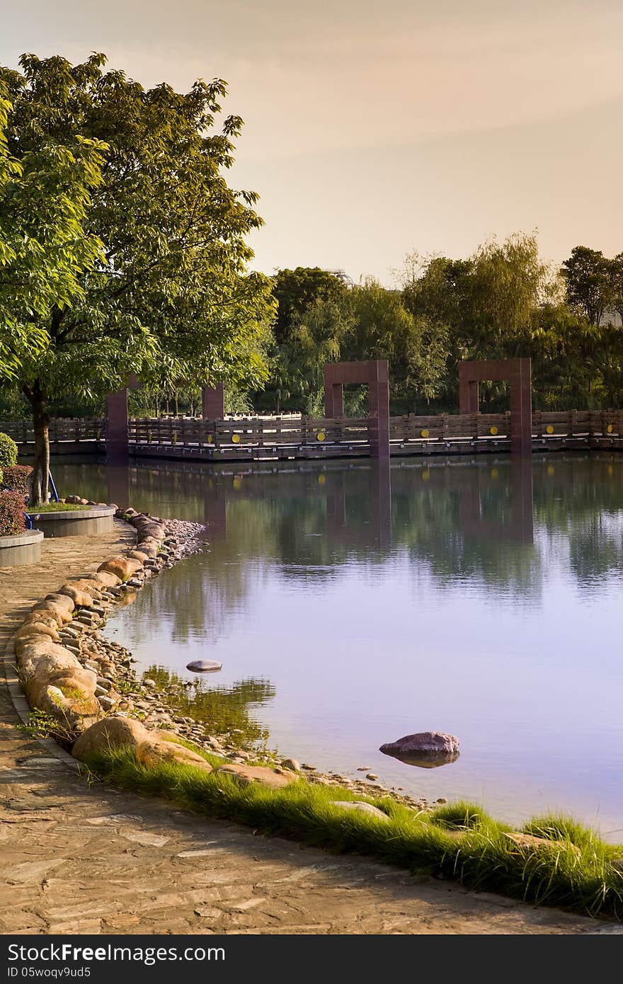 Autumn lake with a footbridge at sunset. Autumn lake with a footbridge at sunset