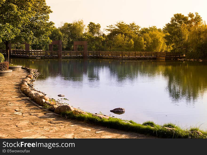 Autumn lake with a footbridge at sunset. Autumn lake with a footbridge at sunset