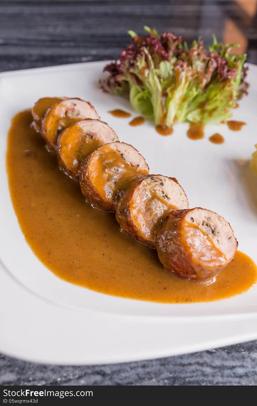 Sliced german sausage with sauce