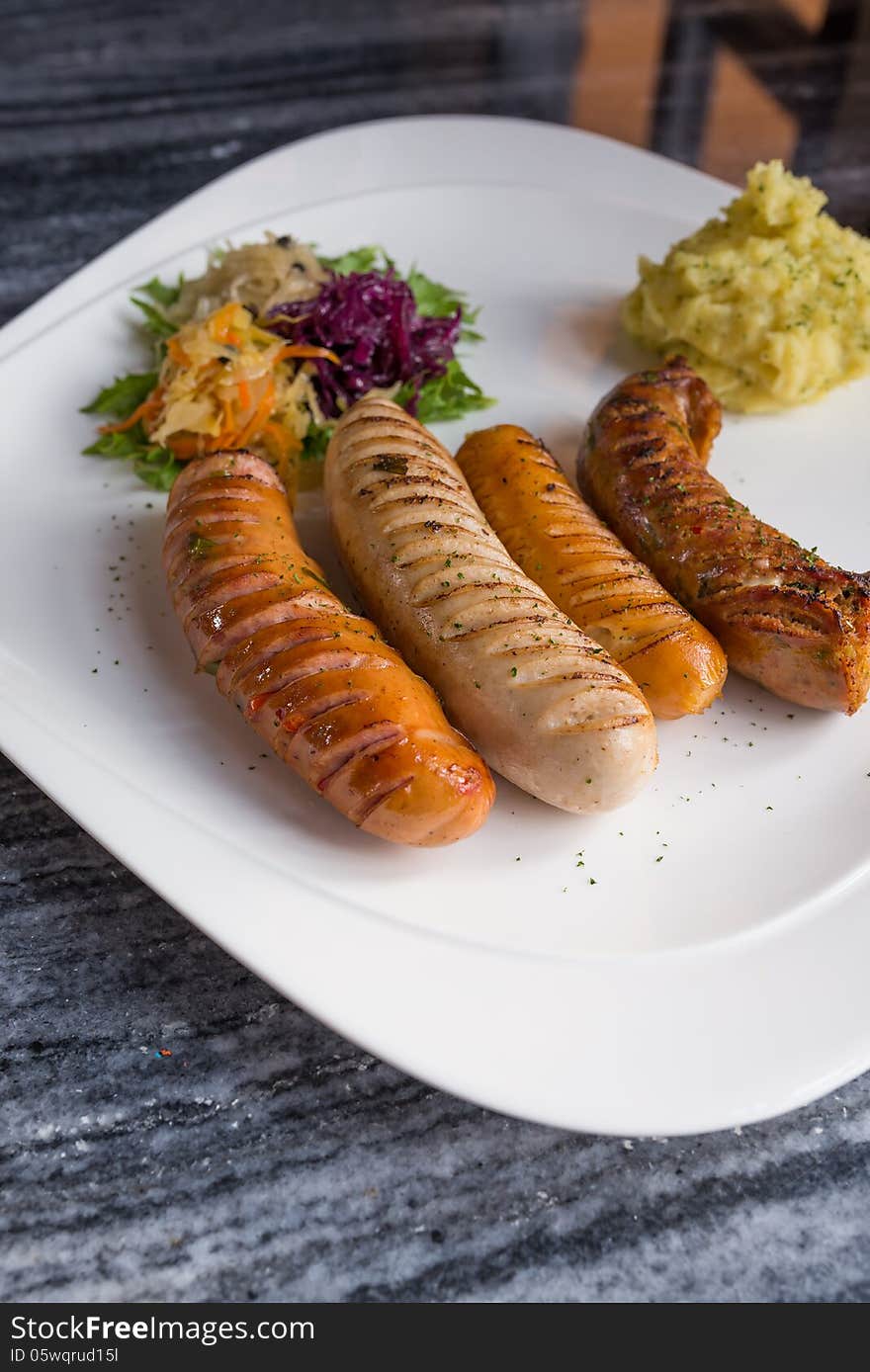 Variety of Germany sausages serve with mini salad