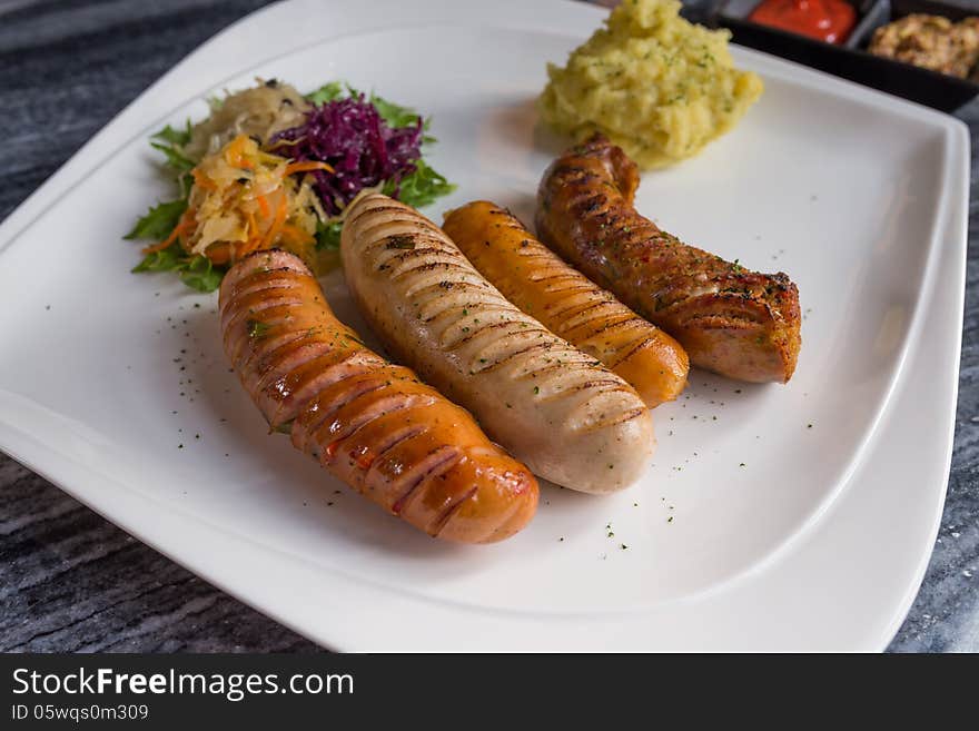 Variety of Germany sausages serve with mini salad