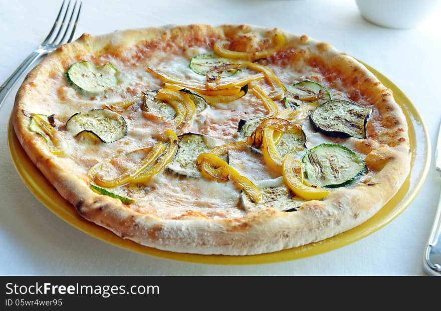 Vegetarian pizza with eggplant and peppers on a plate