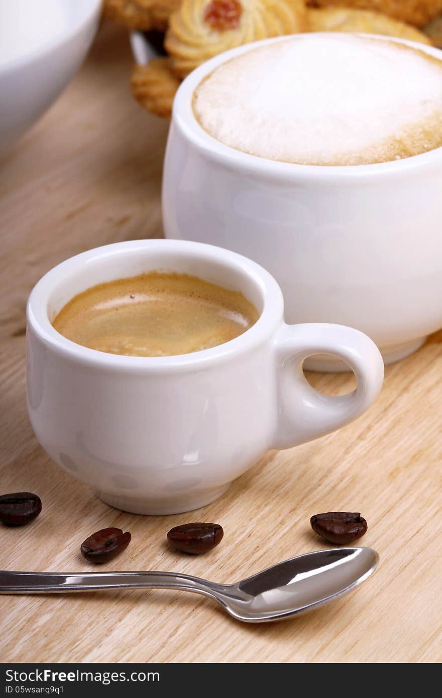 Coffee grains with cup of coffee on a wooden surface of chestnut. Coffee grains with cup of coffee on a wooden surface of chestnut