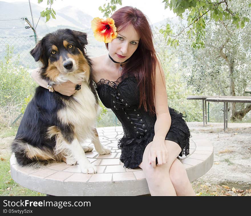 Portrait of gothic woman with australian shepherd dog