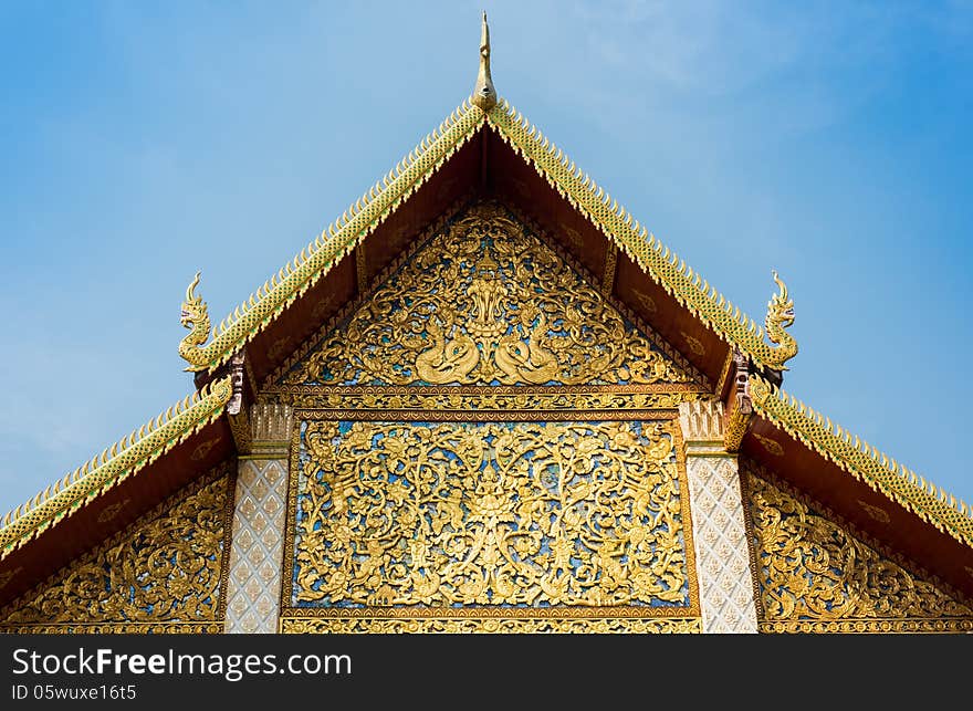 The roof gable or tympanum of temple in Lamphun Province, Thailand. The roof gable or tympanum of temple in Lamphun Province, Thailand