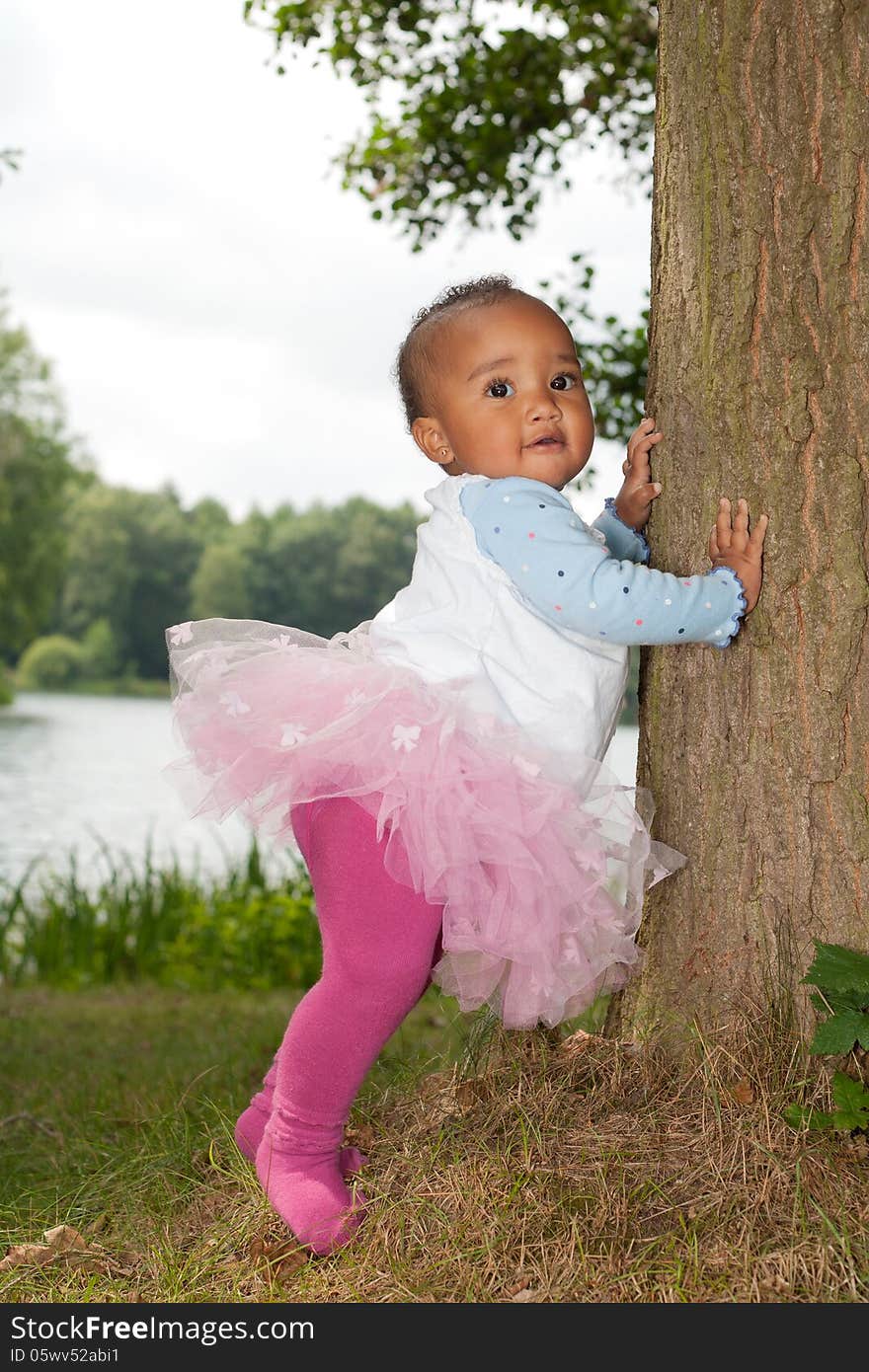 African Little Girl Is Holding The Tree