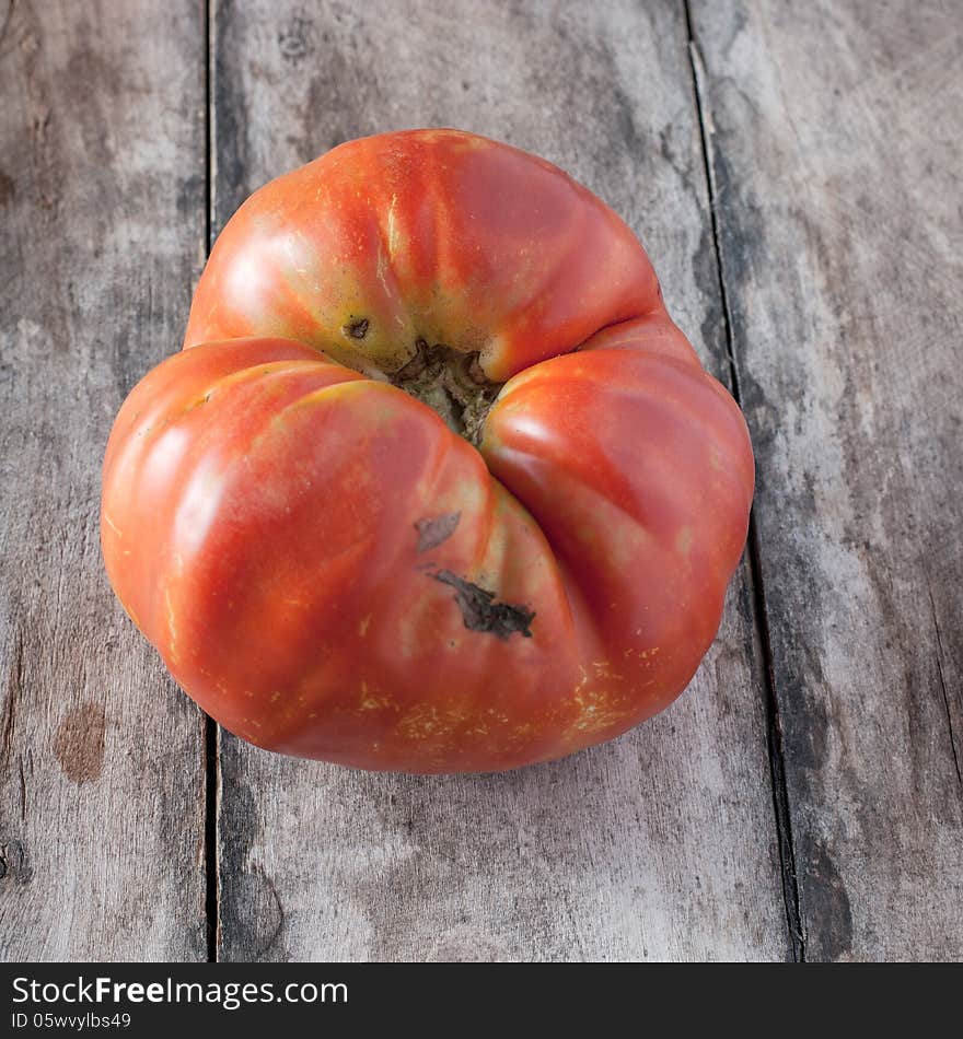 Homemade organic tomato on old wooden table