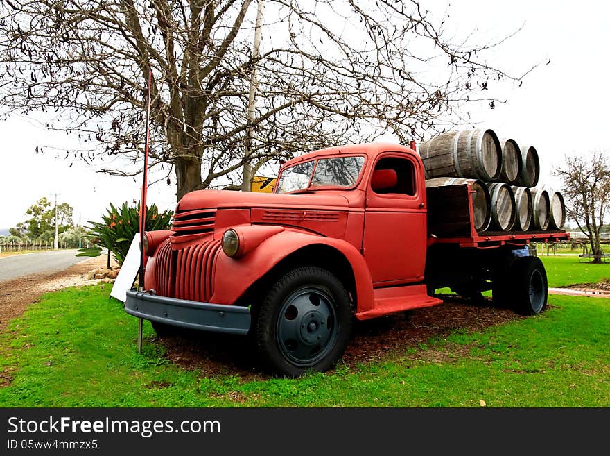 Old red farm truck loaded with barrels. Old red farm truck loaded with barrels.