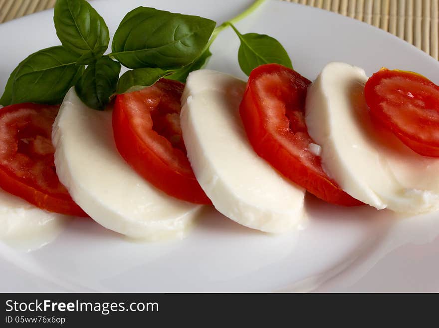 Dish on a white plate of mozzarella tomato basil