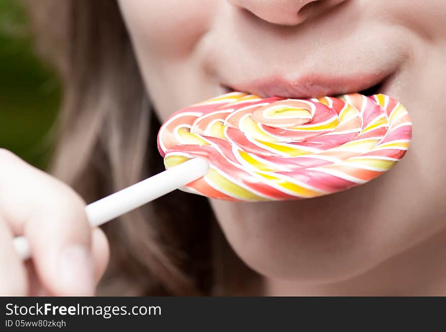 Girl holds a color lollipop