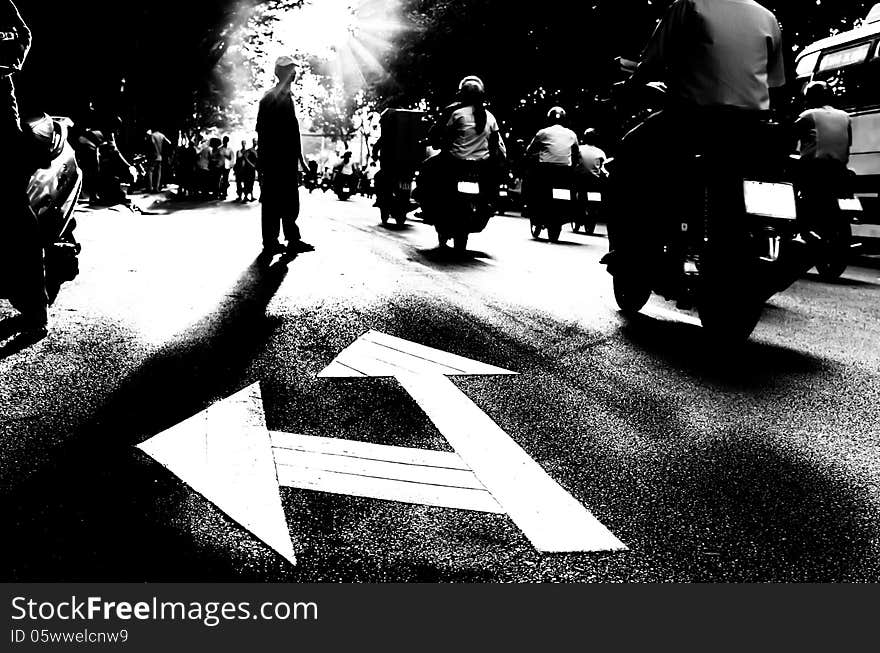 Silhouette of a Pedestrian crossing traffic Street