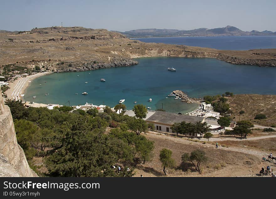 View from above of the main water sea beach in Lindos on the Island of Rhodes Greece photo. Travel concept. View from above of the main water sea beach in Lindos on the Island of Rhodes Greece photo. Travel concept.