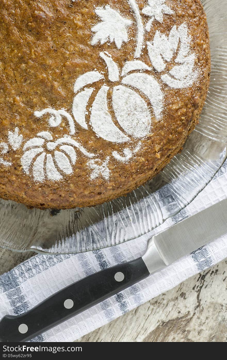 Pumpkin cake on glass plate and knife