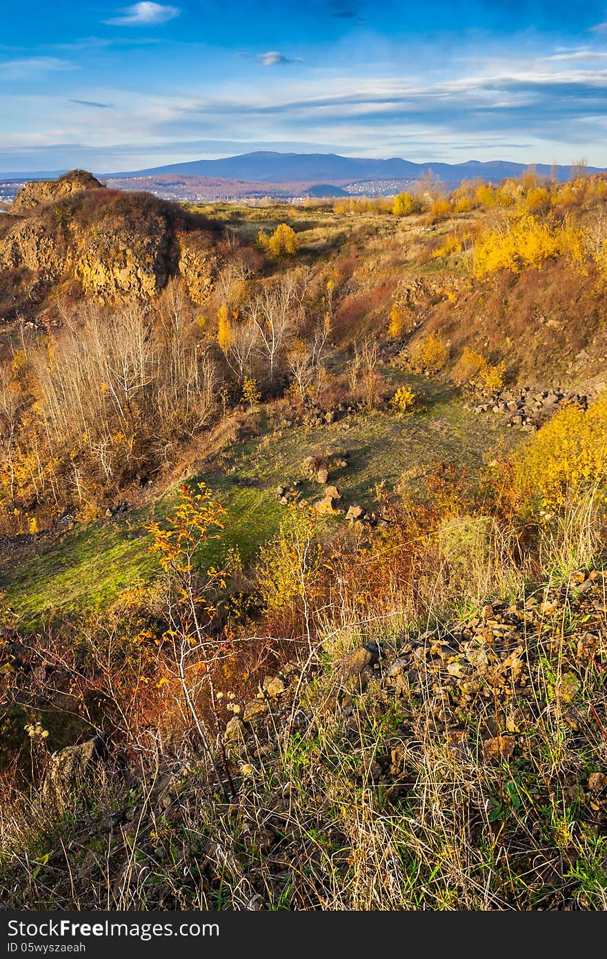 Autumn landscape. the view from the high hill to the valley and the mountains far away. horizontal. Autumn landscape. the view from the high hill to the valley and the mountains far away. horizontal