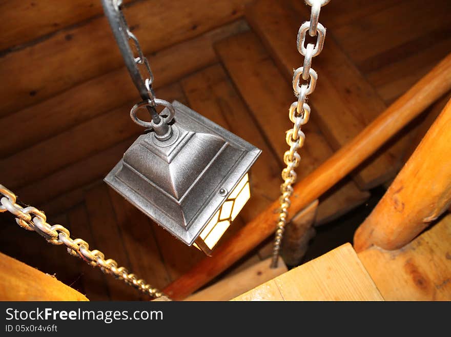 Black lantern with candle that lights the wood stairs. Black lantern with candle that lights the wood stairs