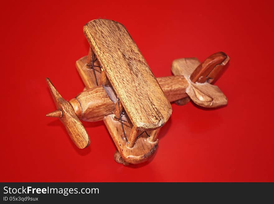 Wooden Toy Plane on a red background