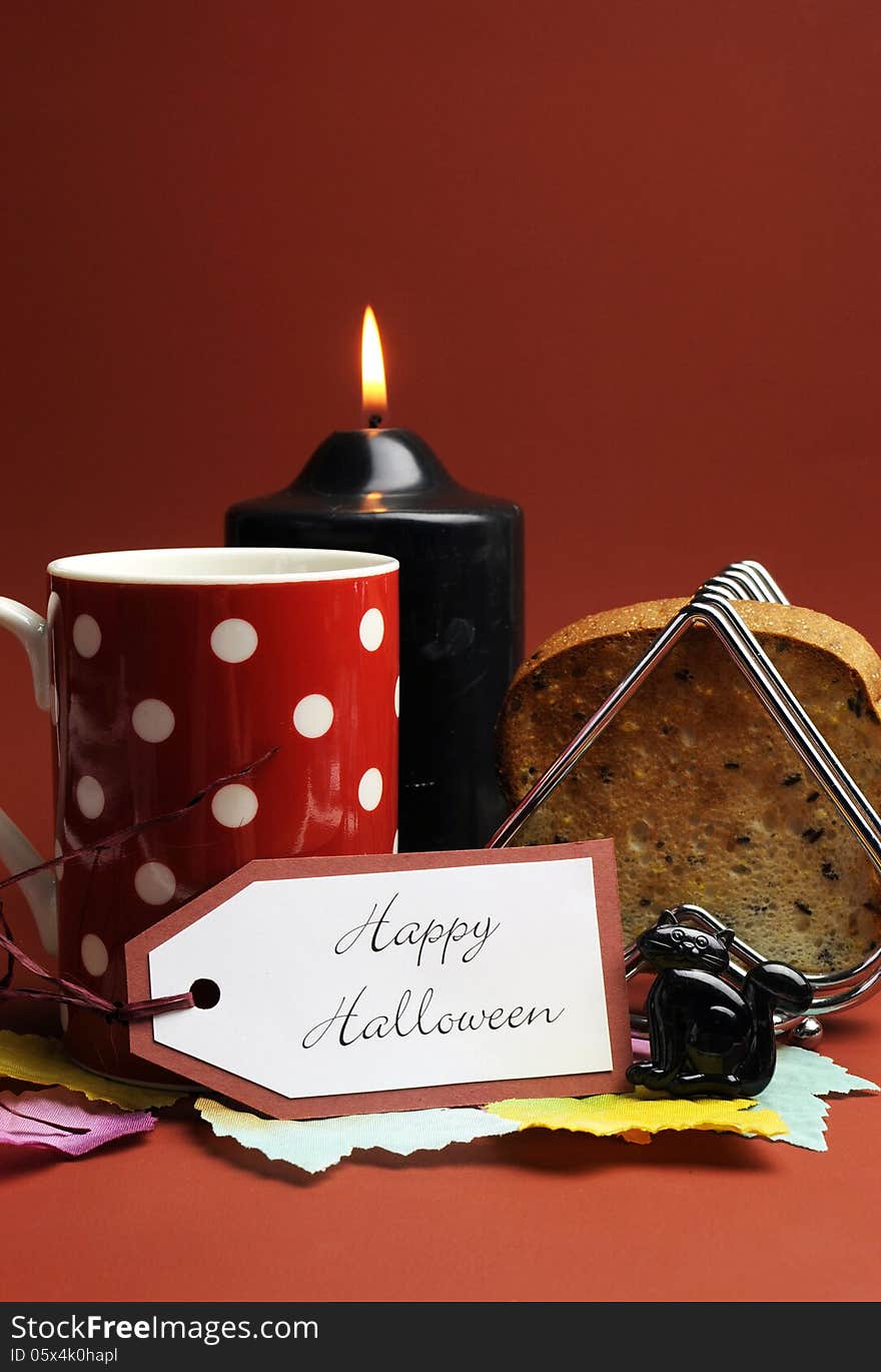 Happy Halloween morning breakfast with red polka dot coffee tea cup mug and toast with black candle and cat on autumn brown background. Happy Halloween morning breakfast with red polka dot coffee tea cup mug and toast with black candle and cat on autumn brown background.