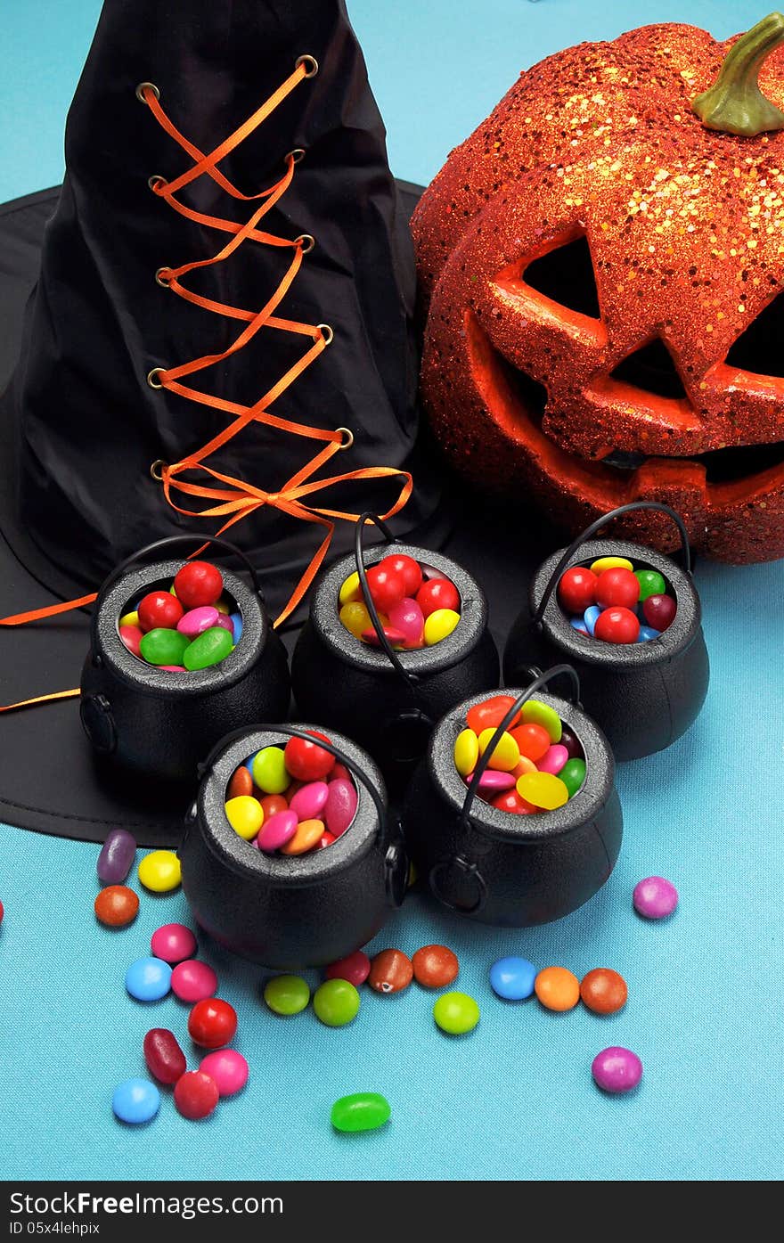 Halloween witch cauldrons full of candy - Vertical.