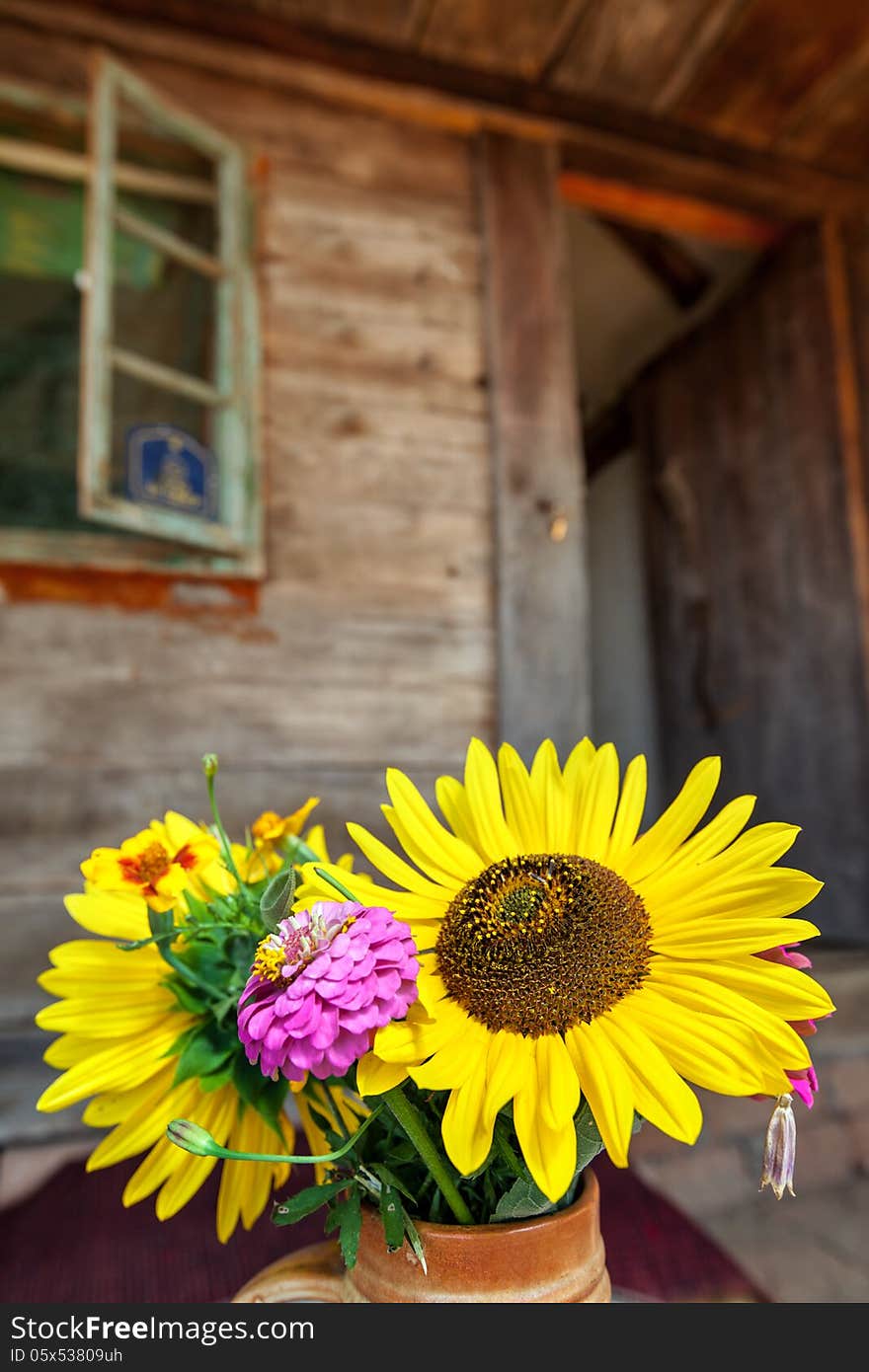 Flowers in front of old wooden house. Flowers in front of old wooden house.