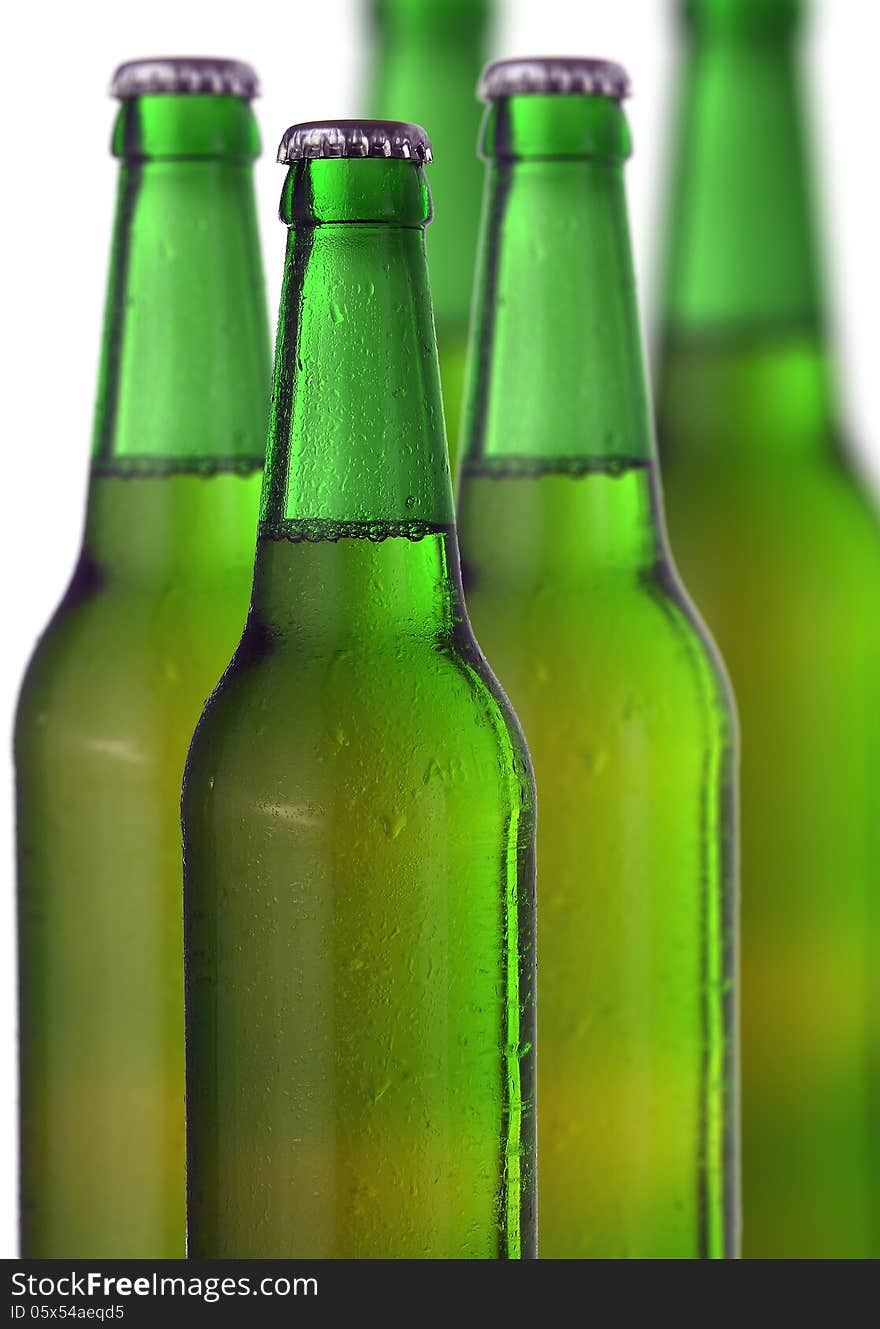 Row of beer bottles on a white