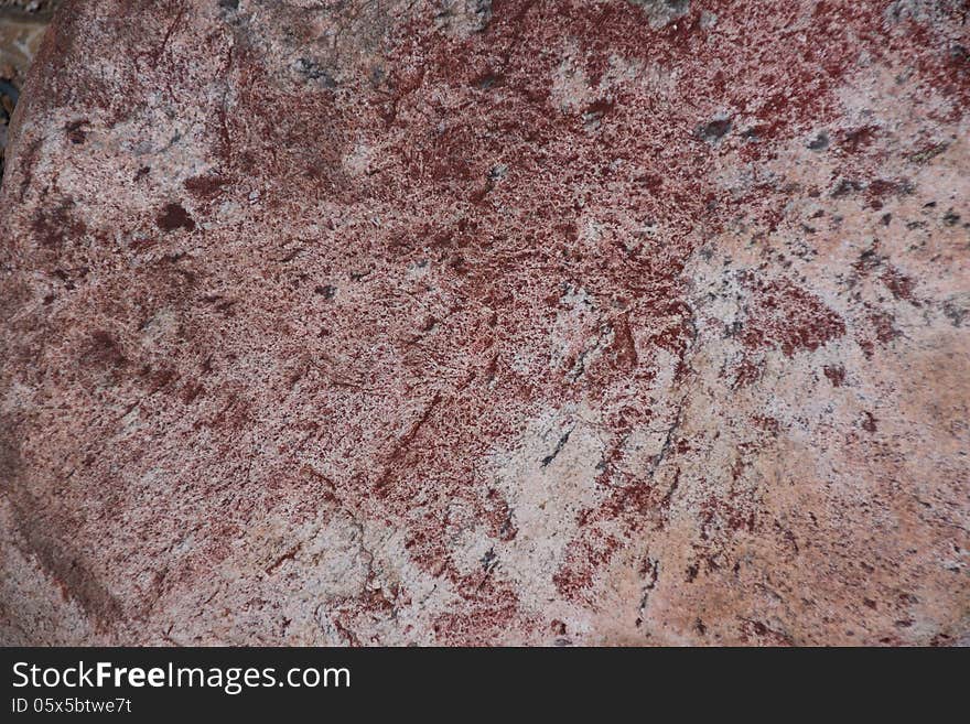 Surface of natural dark red stone (crimson quartzite porphyry) as background. Surface of natural dark red stone (crimson quartzite porphyry) as background