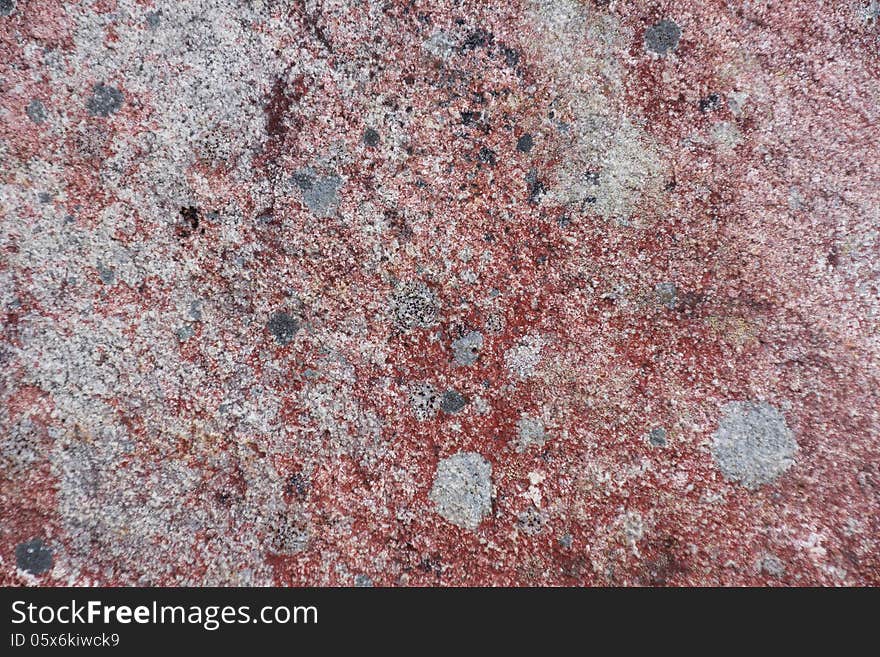 Surface of natural red and gray spotted stone as background. Surface of natural red and gray spotted stone as background