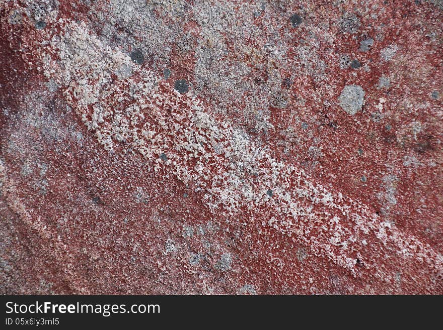 Surface of natural red and gray spotted stone with line as background. Surface of natural red and gray spotted stone with line as background