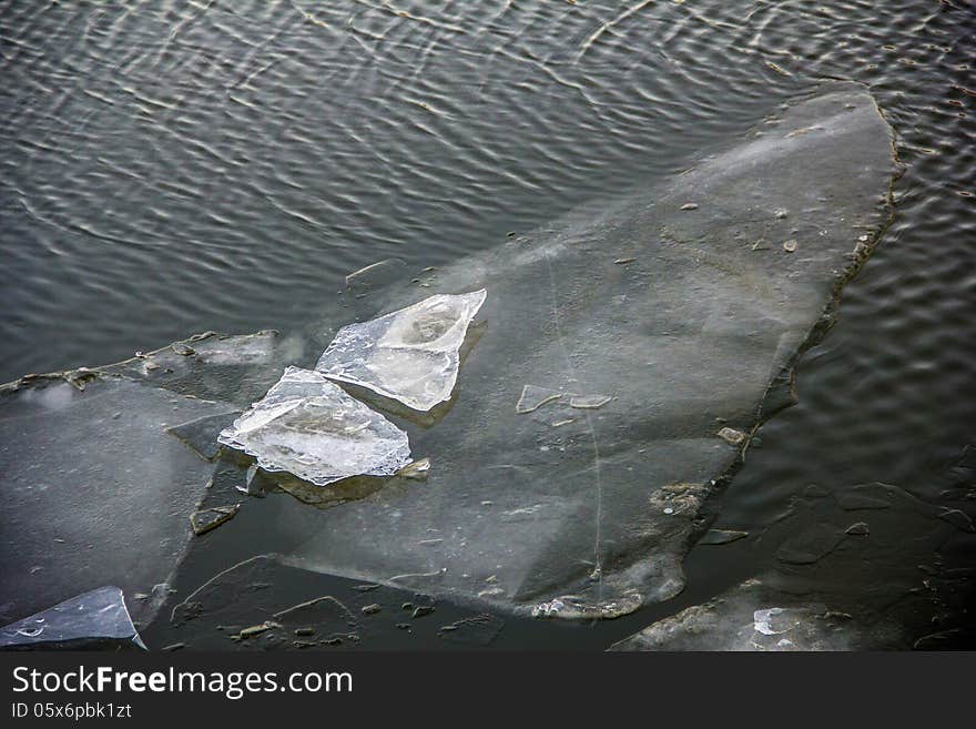 Crystal ice on winter deep shiny water