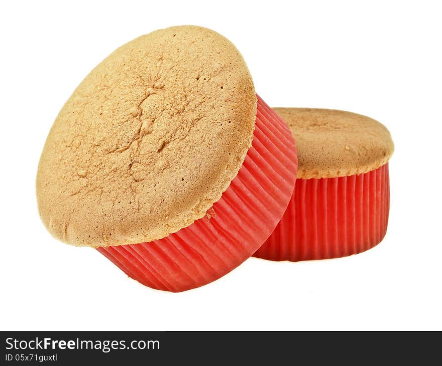 Pile of delicious sponge cake in red paper cup on white background. Pile of delicious sponge cake in red paper cup on white background