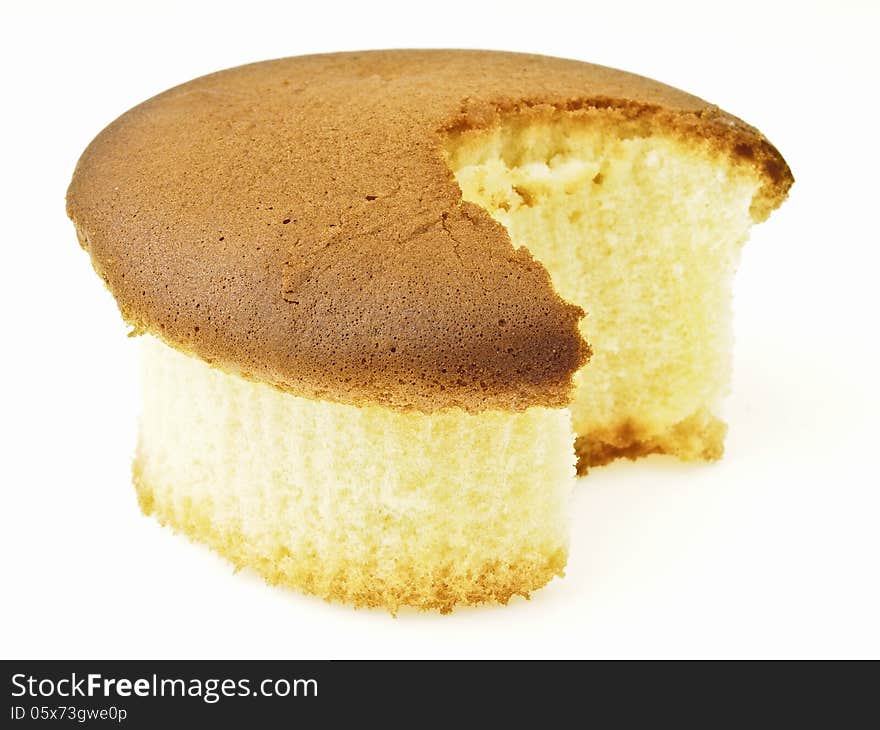 Sponge cake after small bite on white background. Sponge cake after small bite on white background