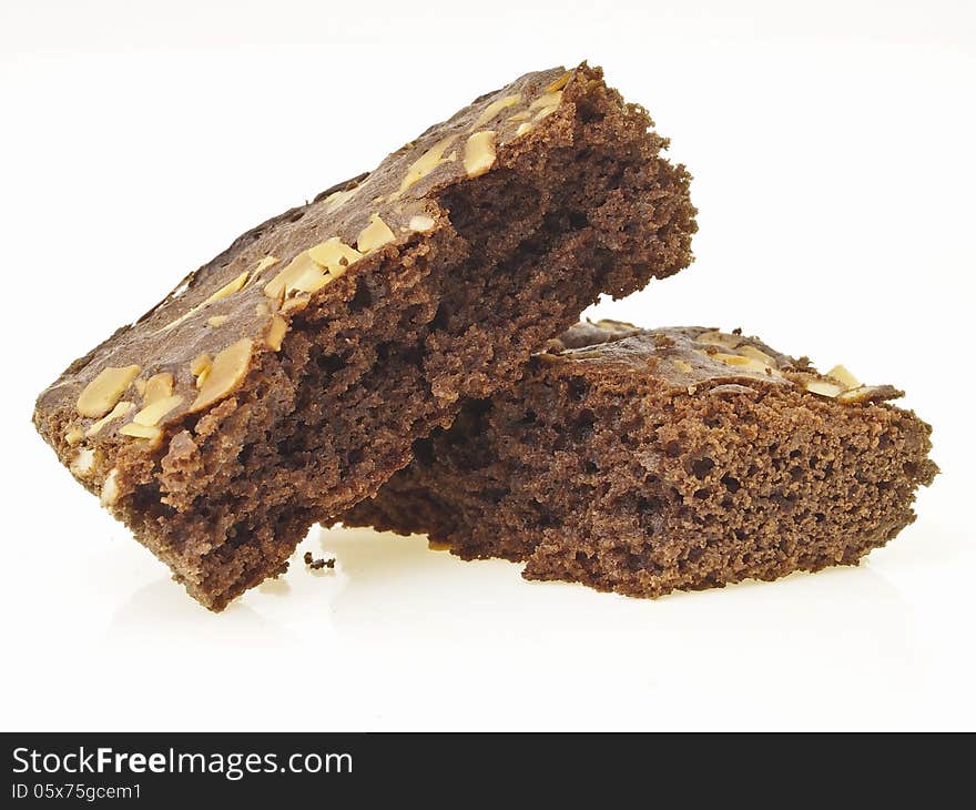 Pile of broken almonds brownies on white background. Pile of broken almonds brownies on white background