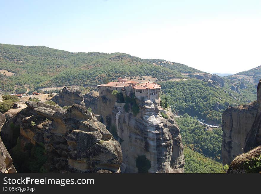 The big complexe Meteora in the sunny summer lovely day. High building build on the tall rock in Greece. One of the most popular touristic place and wonder. The big complexe Meteora in the sunny summer lovely day. High building build on the tall rock in Greece. One of the most popular touristic place and wonder