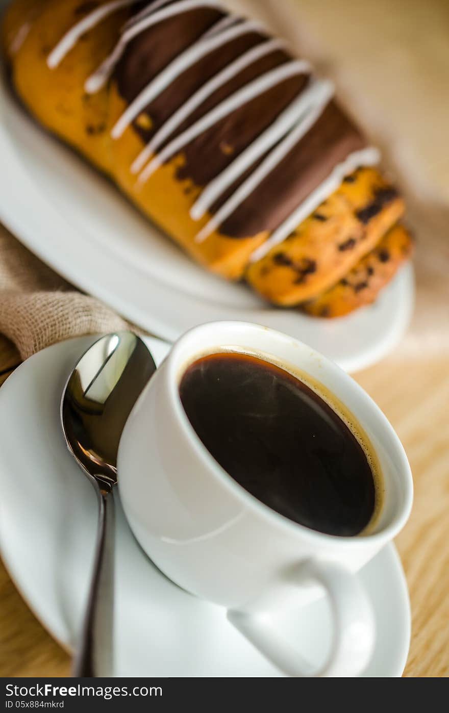 Chocolate bun with cup of coffee. Chocolate bun with cup of coffee