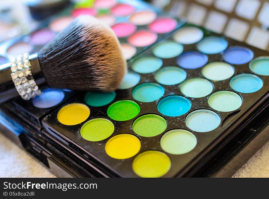 Closeup of makeup kit and brush