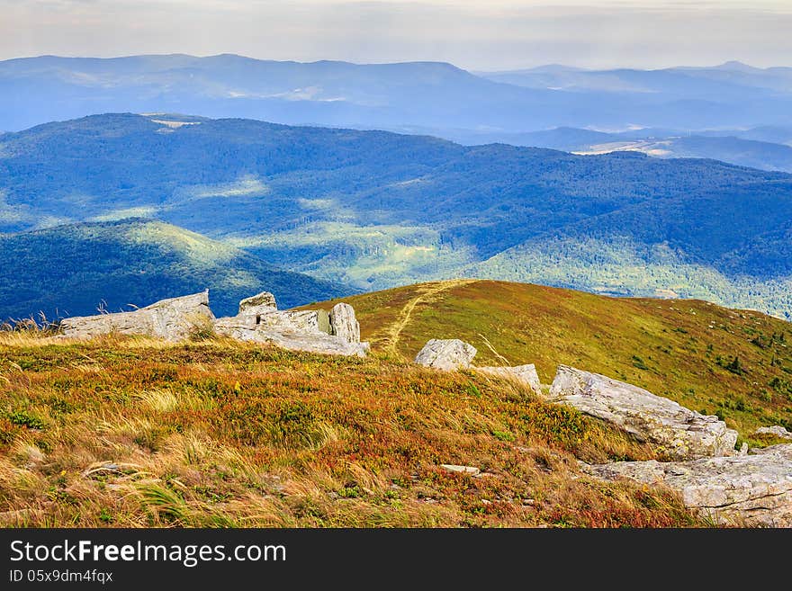 Footpath at the hill top leading into mountains