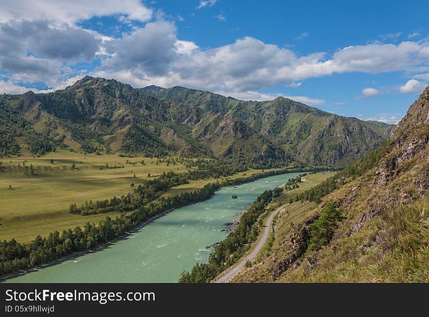 Turquoise river mountains sky