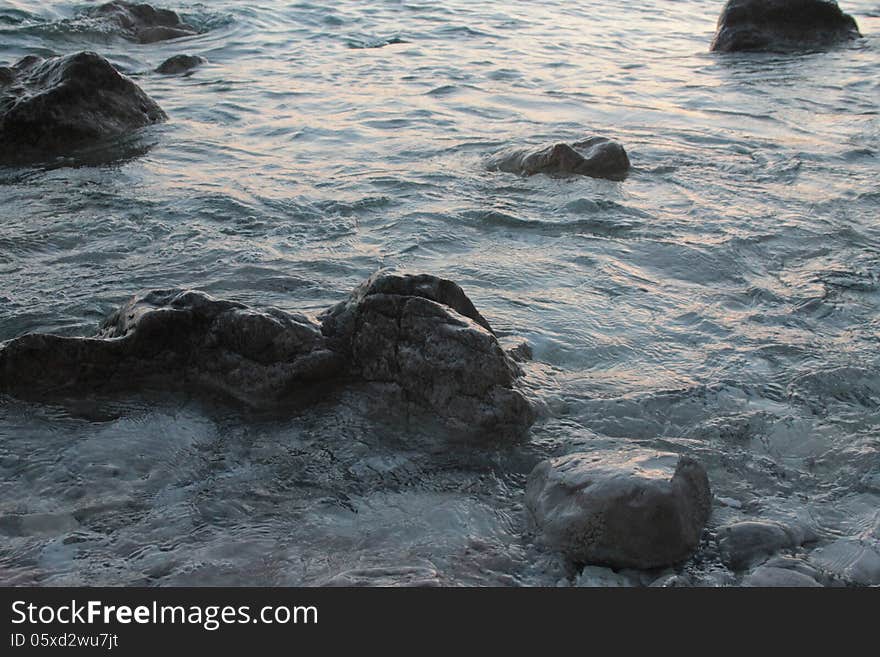 Rocks on the shoreline, blue sea. Rocks on the shoreline, blue sea