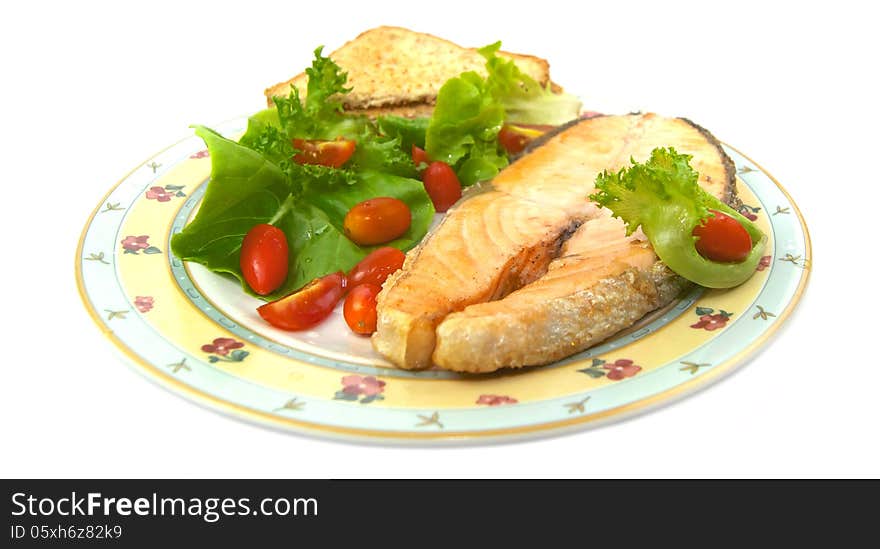 Grilled salmon with vegetables isolated on white