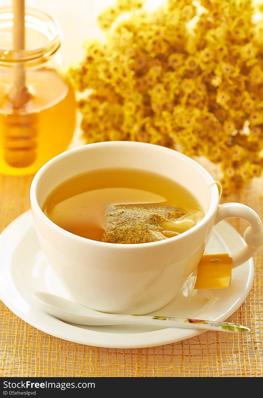 Medicinal herbal tea in white cup with honey. Medicinal herbal tea in white cup with honey