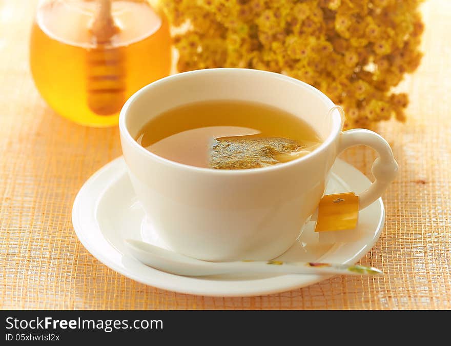 Medicinal herbal tea in white cup with honey. Medicinal herbal tea in white cup with honey