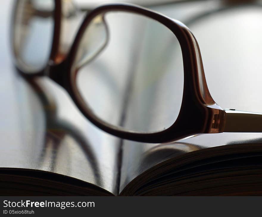 Open book with pages and eyeglasses in close. Open book with pages and eyeglasses in close