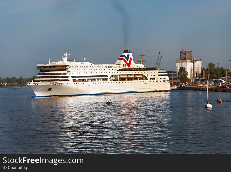 Moored in the harbor of a large white cruise ship. Moored in the harbor of a large white cruise ship