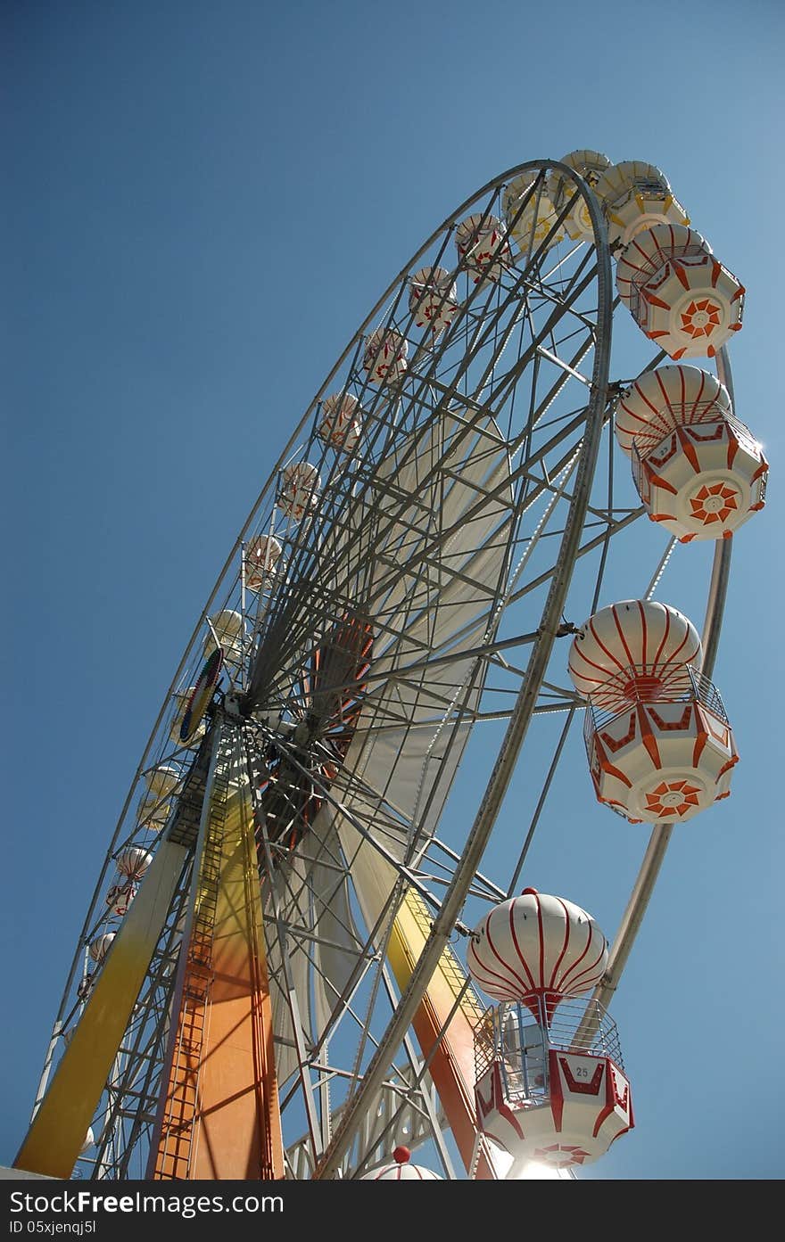 A Ferris wheel (also known as an observation wheel or big wheel) is a nonbuilding structure consisting of a rotating upright wheel with passenger cars (sometimes referred to as gondolas or capsules) attached to the rim in such a way that as the wheel turns, the cars are kept upright, usually by gravity.