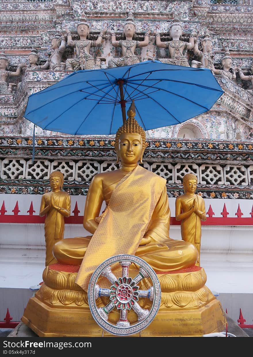 The Buddha statue under the umbrella