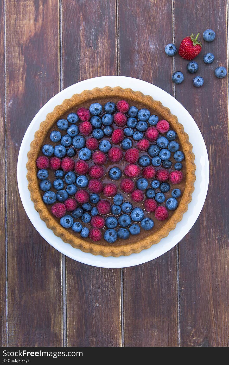 A cake garnished with summer fruit