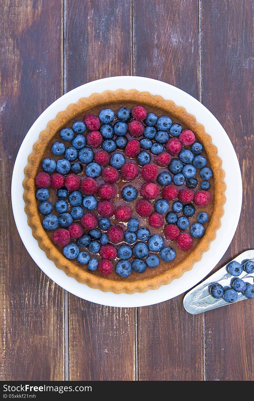 A cake garnished with summer fruit