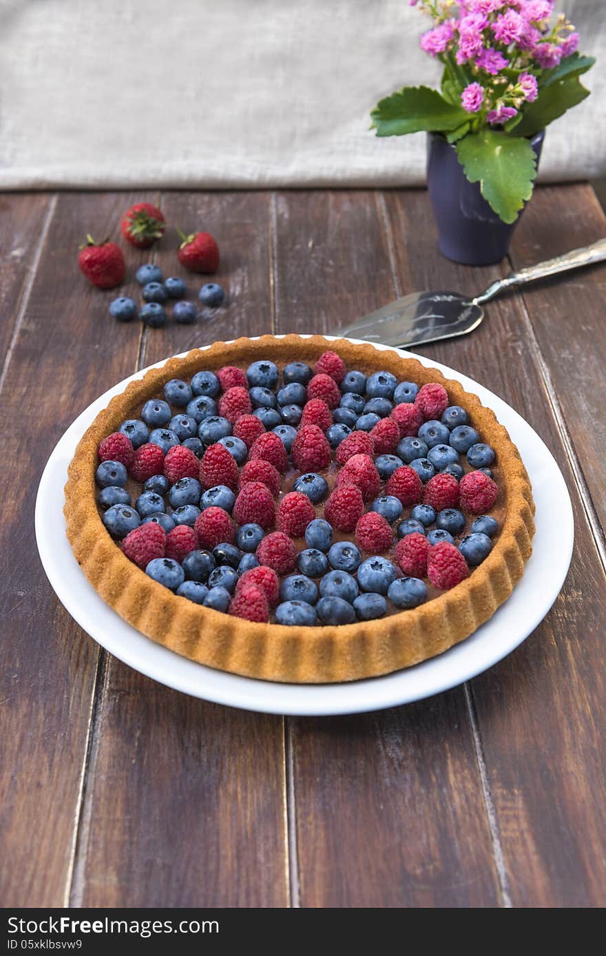 A Cake Garnished With Summer Fruit